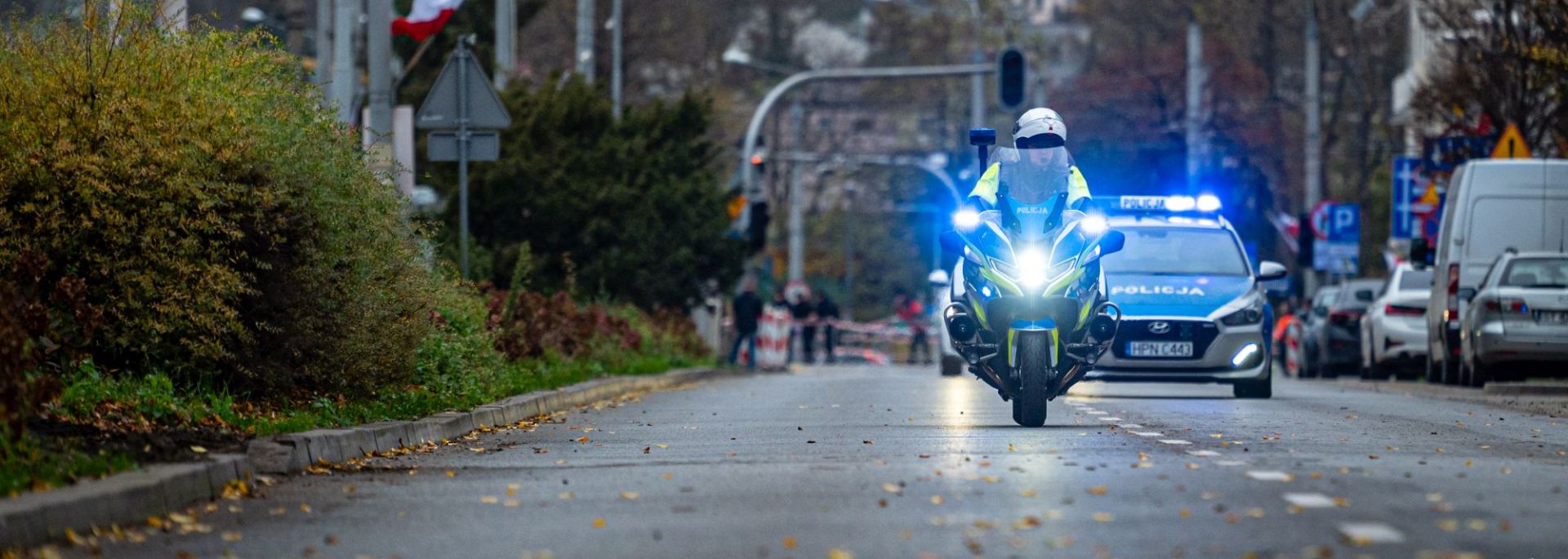 Policyjny motocykl prowadzący biegaczy na trasie biegu