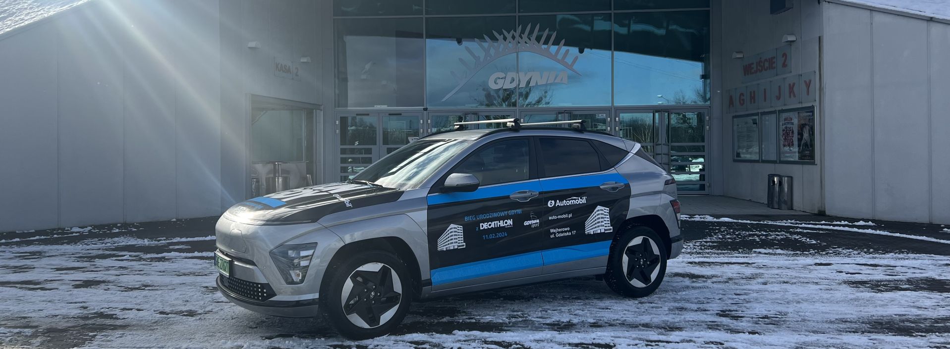 Hyundai Kona obrandowany na tle Polsat Plus Areny Gdynia 